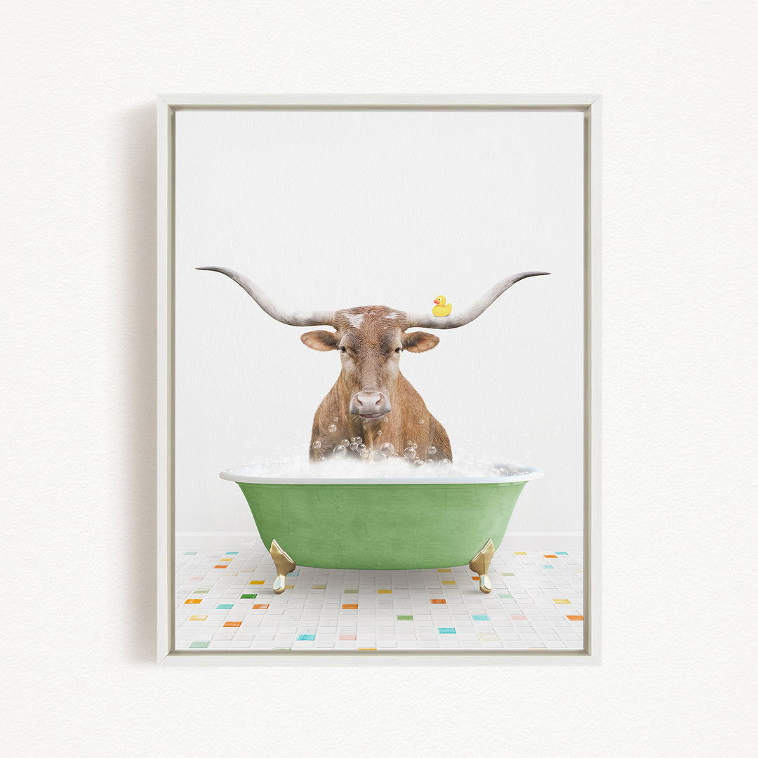 A brown cow with long horns is sitting in a green bathtub filled with bubbles, with a yellow rubber duck floating on the water.