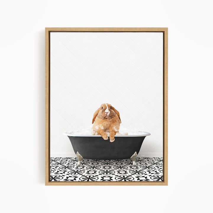 A brown rabbit sitting in a black bathtub filled with water, surrounded by a black and white patterned floor.