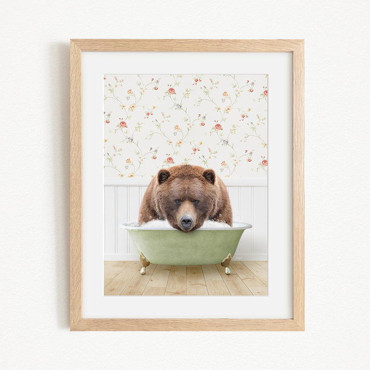 A brown bear is sitting in a green bathtub, surrounded by a floral patterned wall.