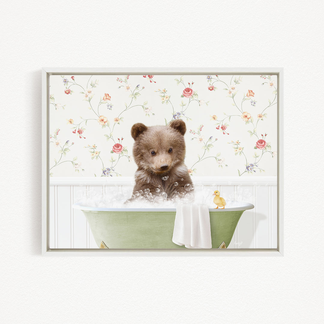 A cute brown bear sitting in a green bathtub filled with bubbles, with a yellow rubber duck floating nearby.