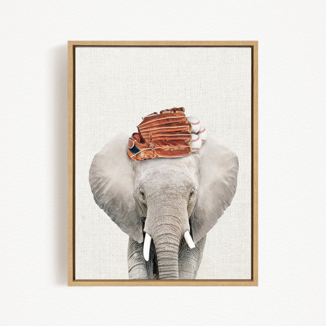 A gray elephant with a baseball glove on its head, standing against a plain white background.