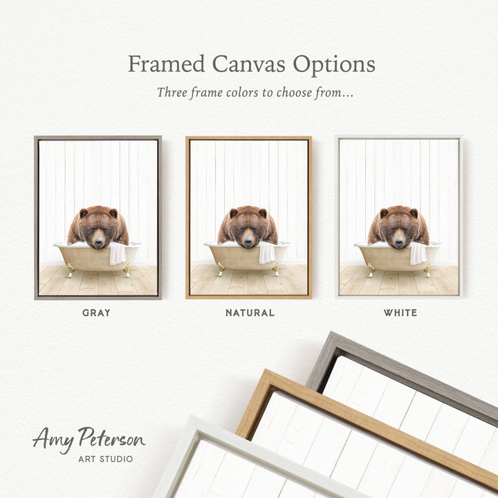 three framed canvas options, each featuring a brown bear sitting in a bathtub. The options include a gray frame, a natural frame, and a white frame.