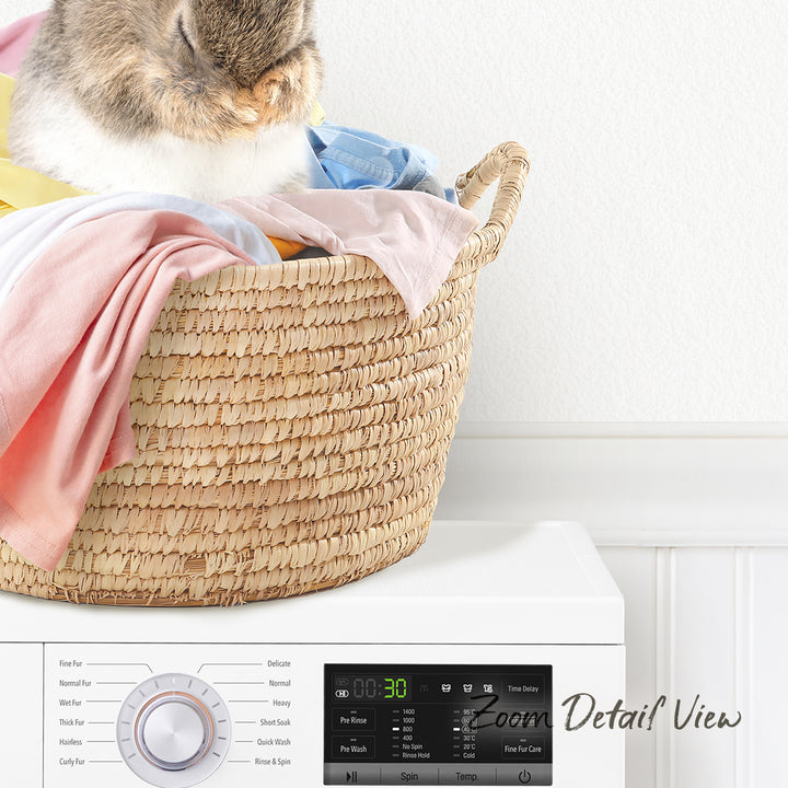 A cat is resting on a basket filled with laundry, sitting on top of a washing machine.