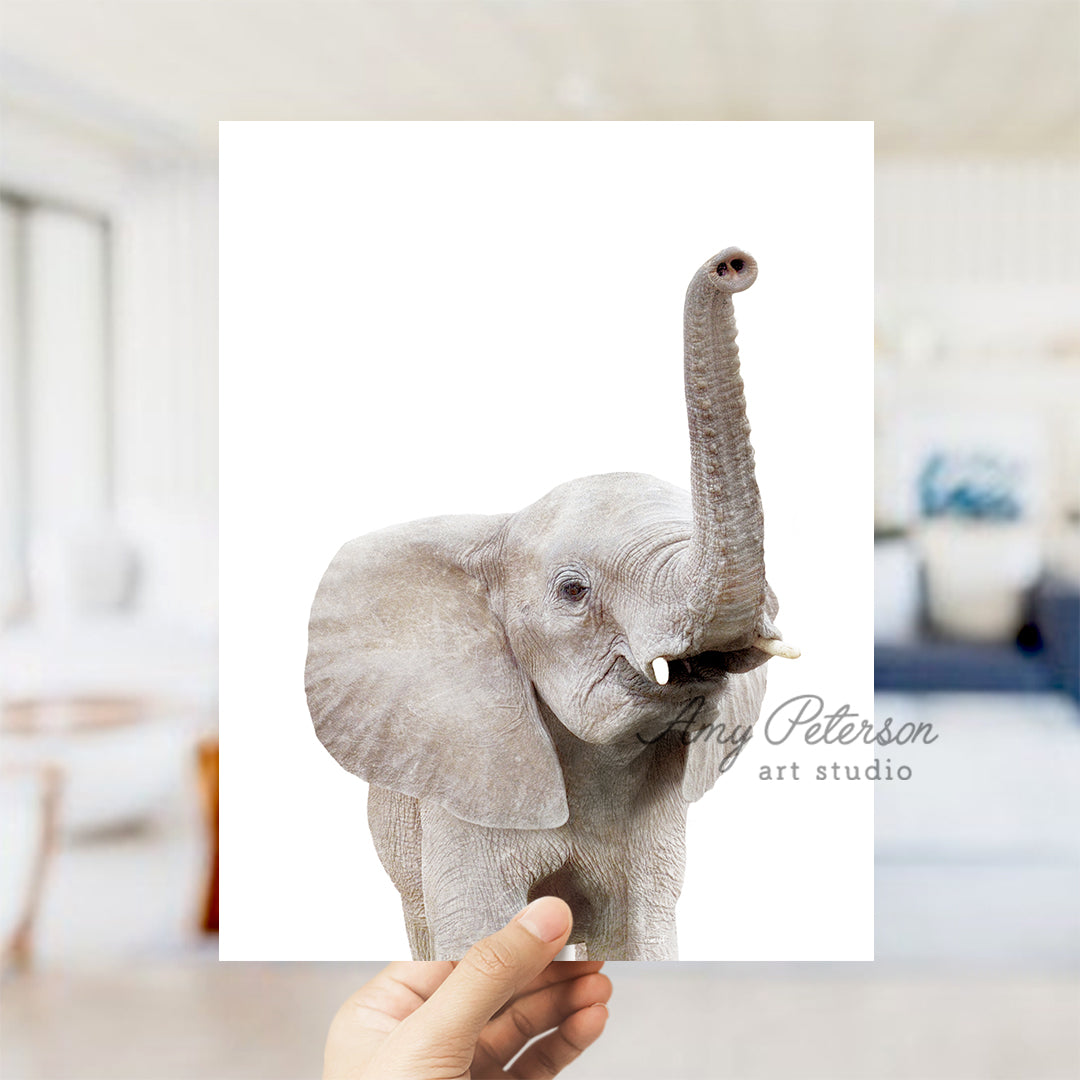 a person holding up a picture of an elephant