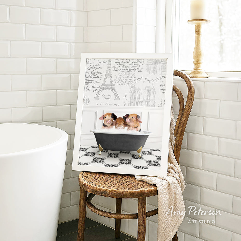 A framed image of two small dogs sitting in a bathtub, with a drawing of the Eiffel Tower in the background.