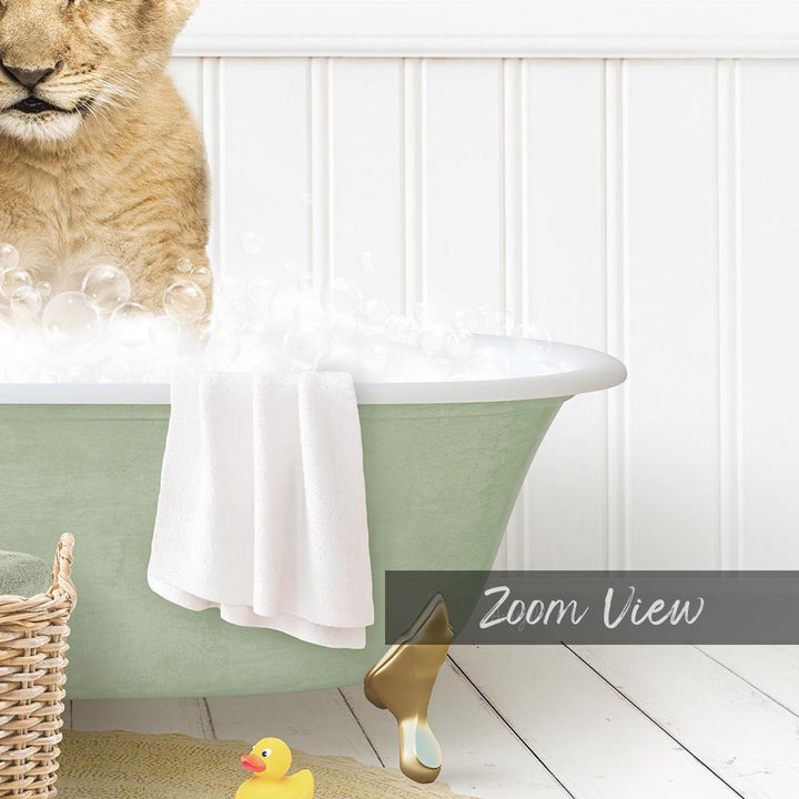 A cat sitting in a green bathtub filled with bubbles, with a yellow rubber duck nearby and a towel draped over the side.
