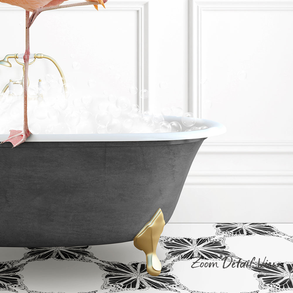 A black clawfoot bathtub filled with water and bubbles, with a gold faucet and footrest, set against a white wall with a black and white floral pattern on the floor.