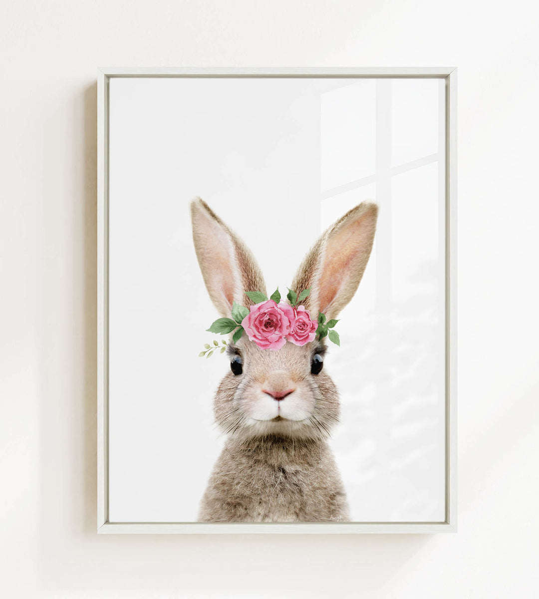 A cute rabbit wearing a pink flower crown on its head, looking directly at the camera.