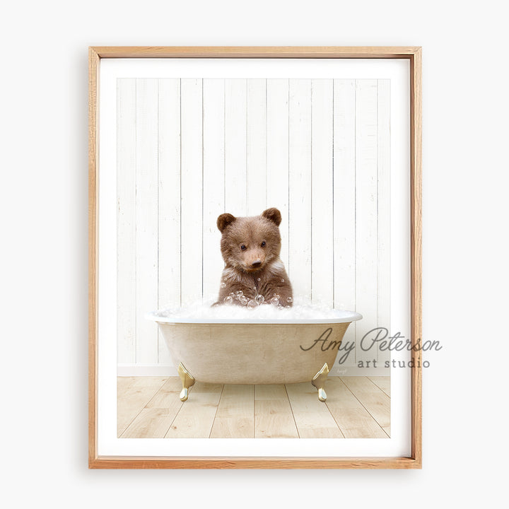 a brown teddy bear sitting in a bath tub