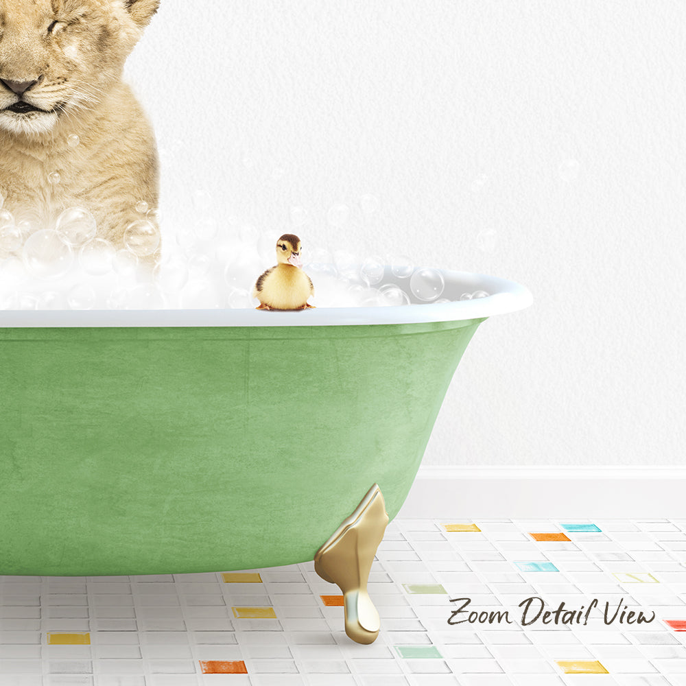 A lion cub is taking a bath in a green bathtub, with a small yellow duck sitting on the edge of the tub.