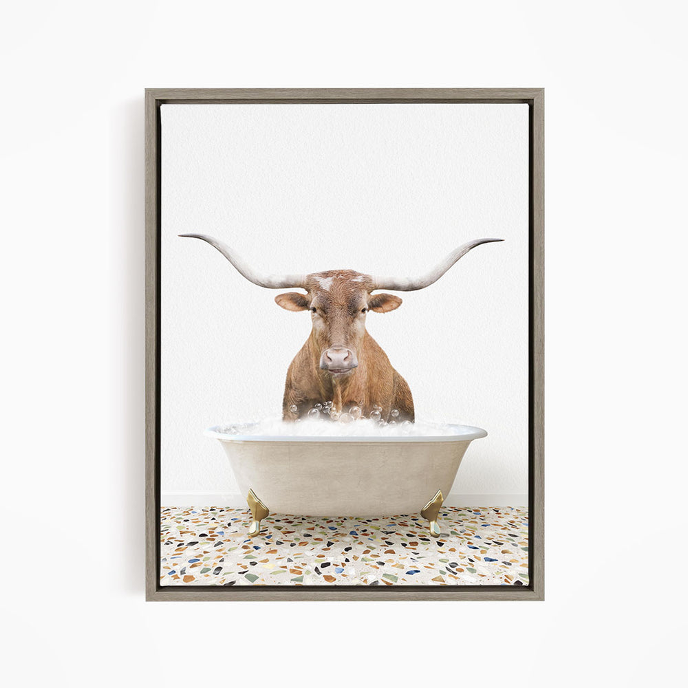A brown cow with large horns is standing in a white bathtub filled with water, creating a humorous and whimsical scene.