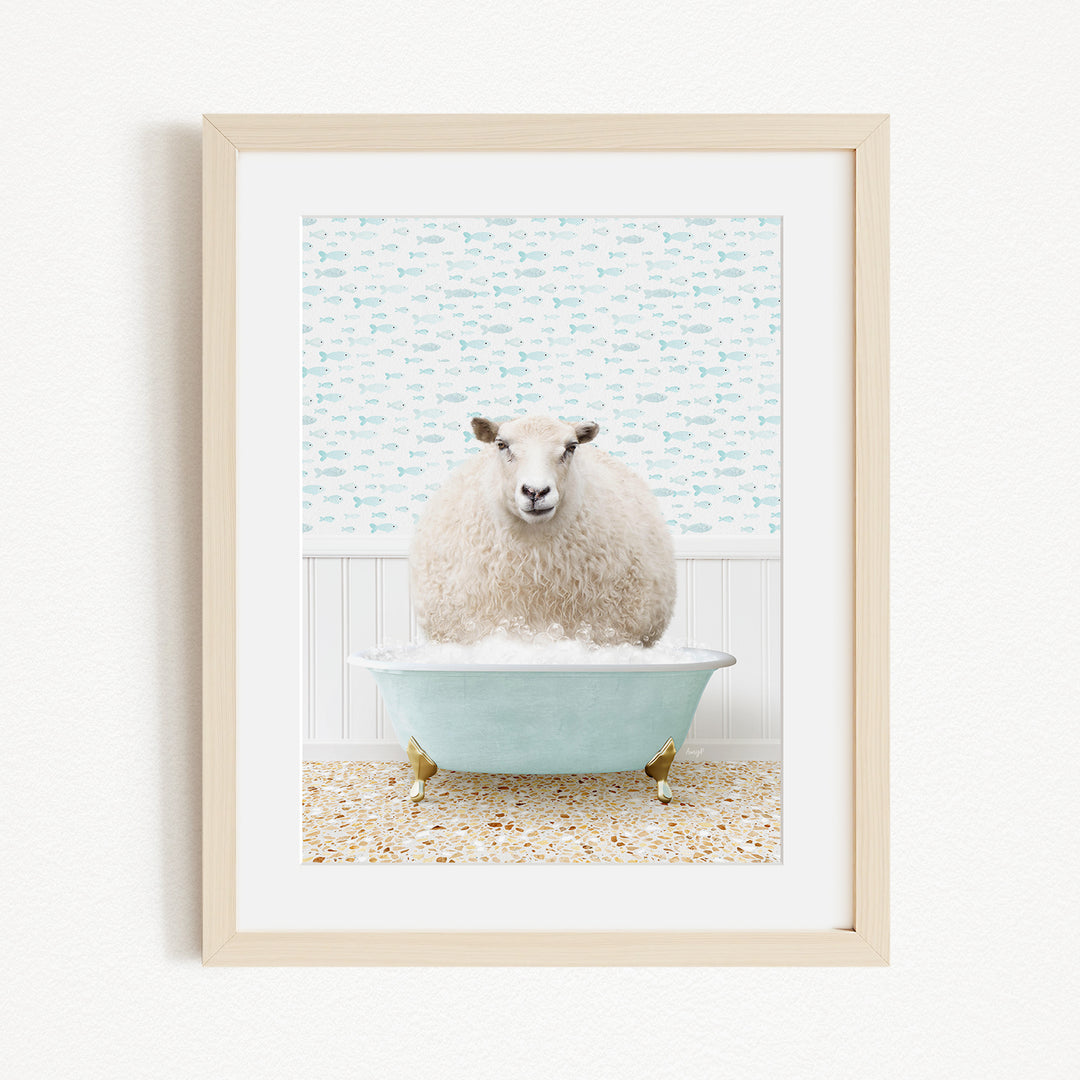 A fluffy white sheep sits in a blue bathtub filled with bubbles, surrounded by a patterned wall and a beige floor.