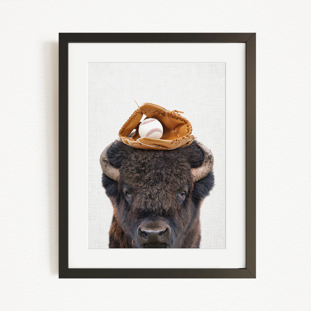 A buffalo with a baseball glove on its head.