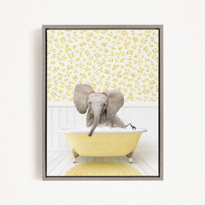 A gray elephant is sitting in a yellow bathtub filled with water, surrounded by a yellow floral wallpaper.