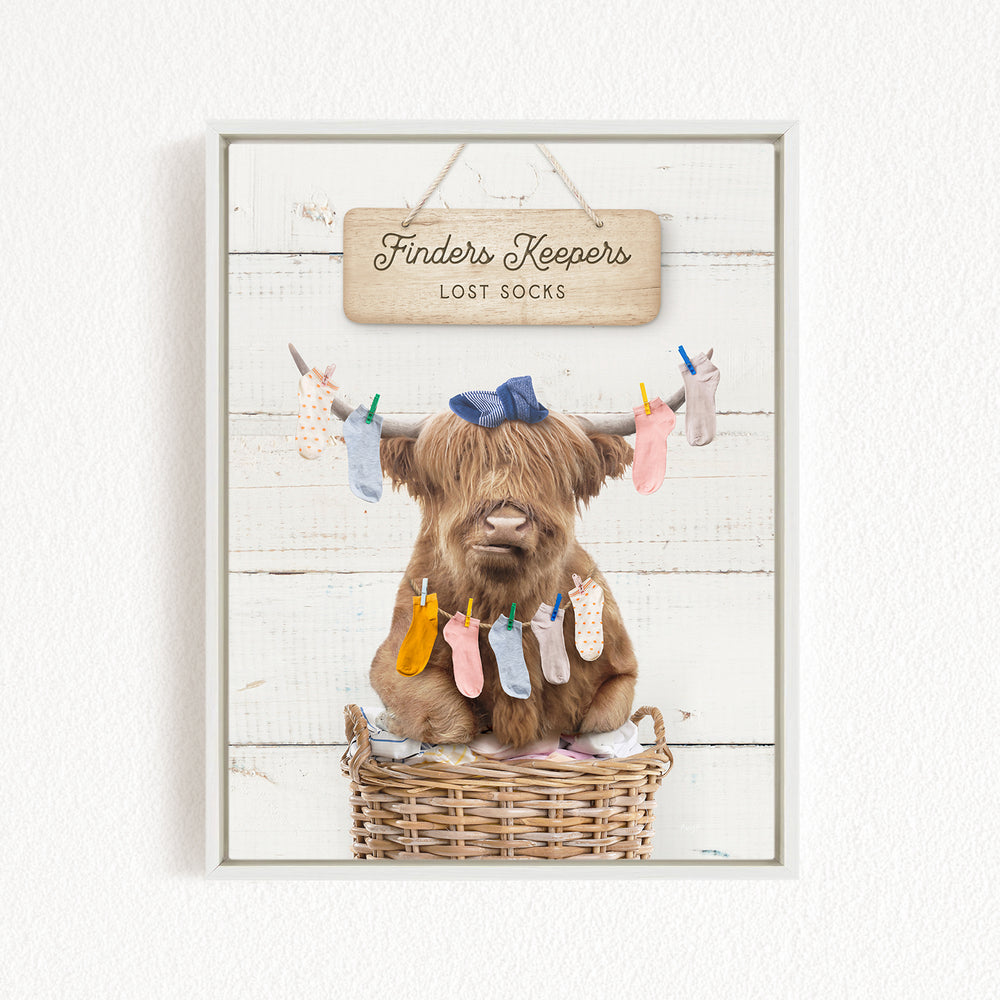 A brown cow with a blue bow sits in a wicker basket, surrounded by colorful socks hanging from clotheslines.