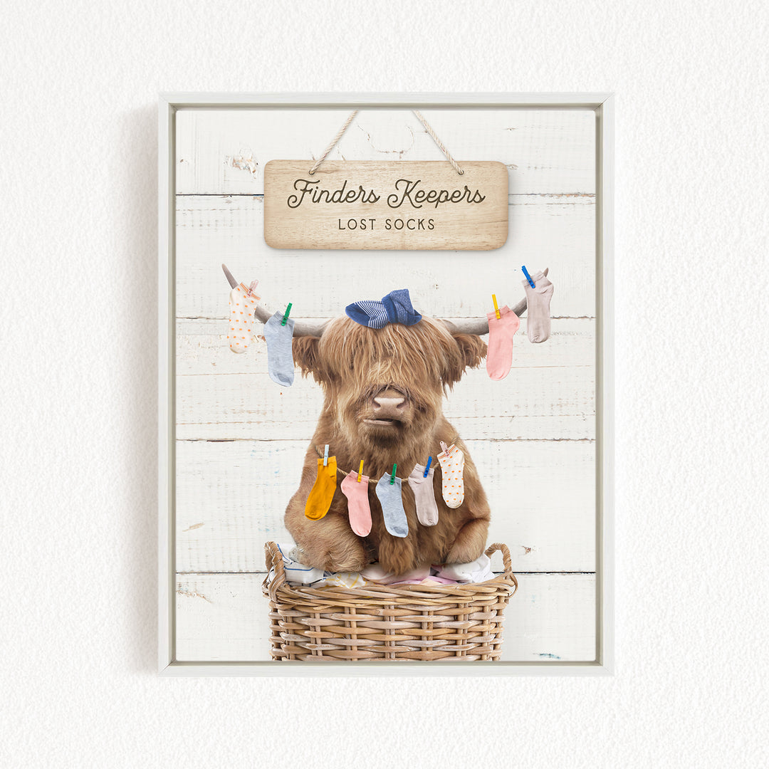 A brown cow with a blue bow sits in a wicker basket, surrounded by colorful socks hanging from clotheslines.