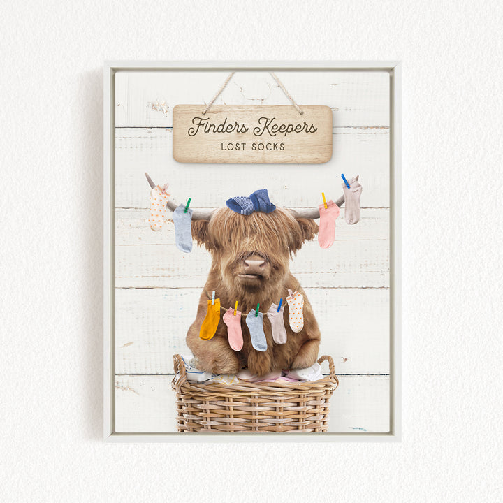 A brown cow with a blue bow sits in a wicker basket, surrounded by colorful socks hanging from clotheslines.