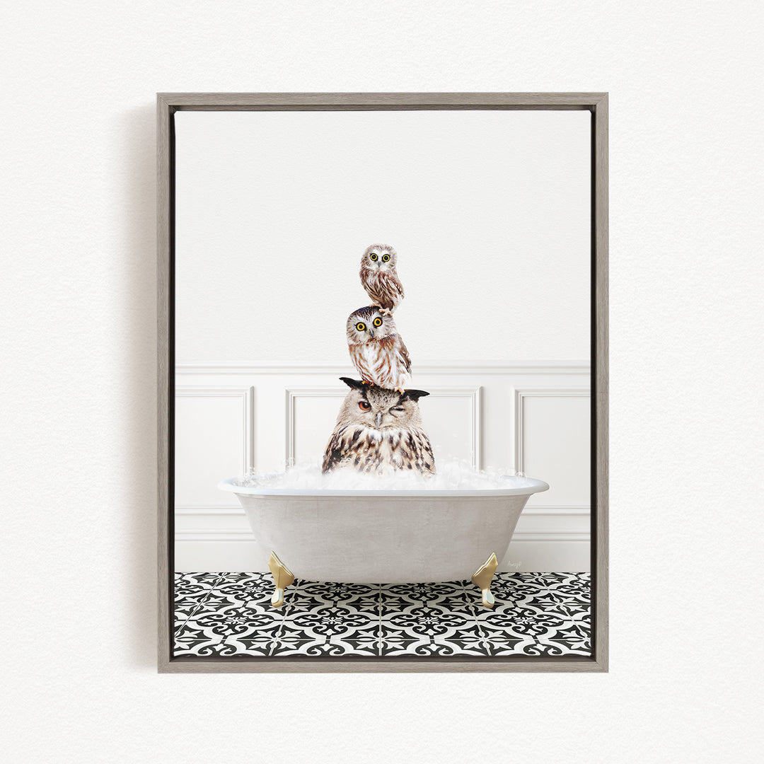 A framed image depicting three owls sitting in a white bathtub filled with water, creating a whimsical and playful scene.