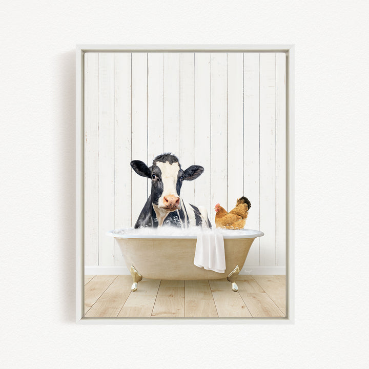 A black and white cow is sitting in a bathtub filled with water, with a chicken nearby, in a white wooden wall.
