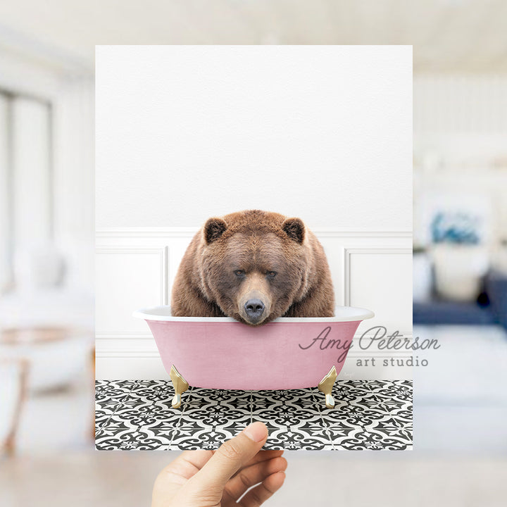 a brown bear sitting in a pink bath tub