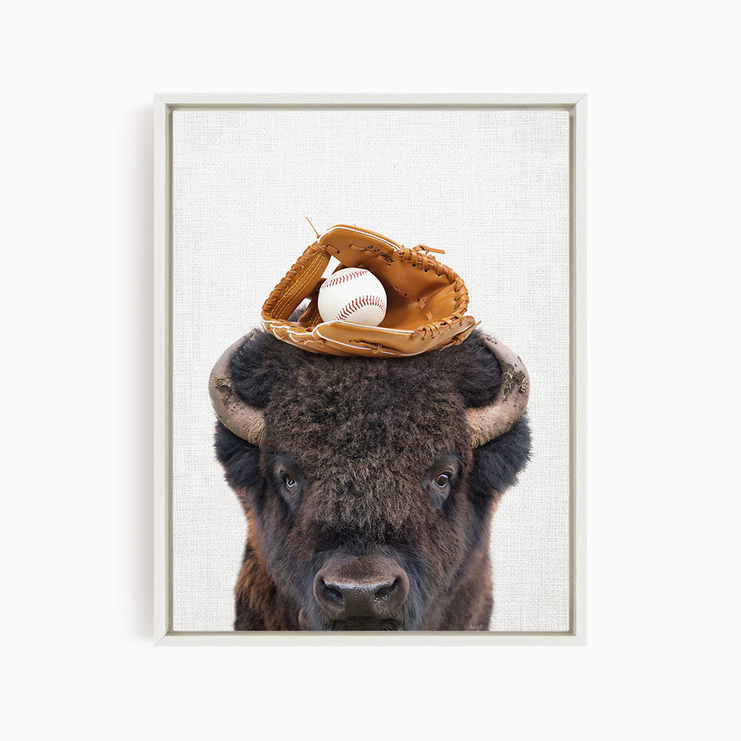 A buffalo with a baseball glove on its head.