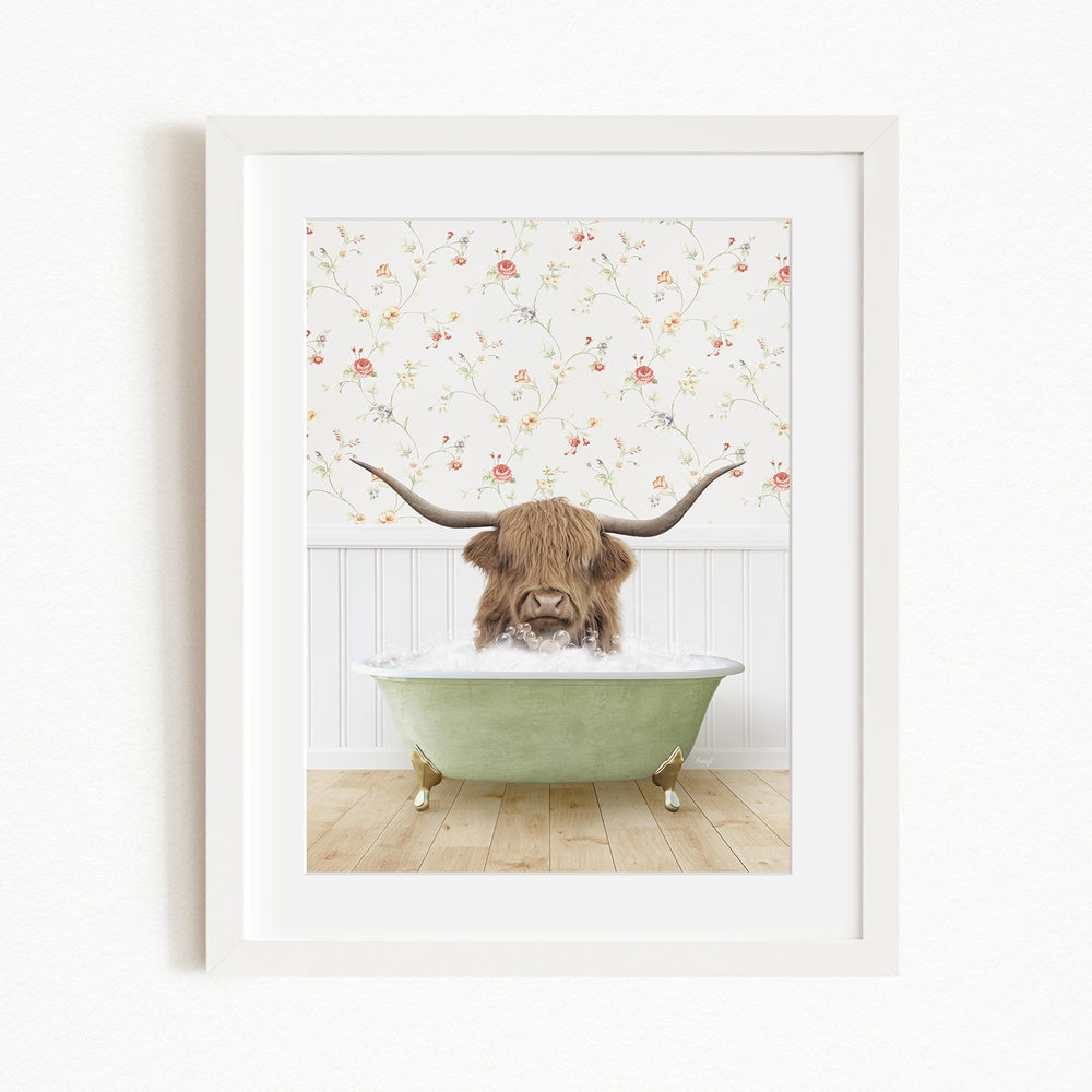 A brown cow with long horns is sitting in a green bathtub, surrounded by a floral wallpaper.