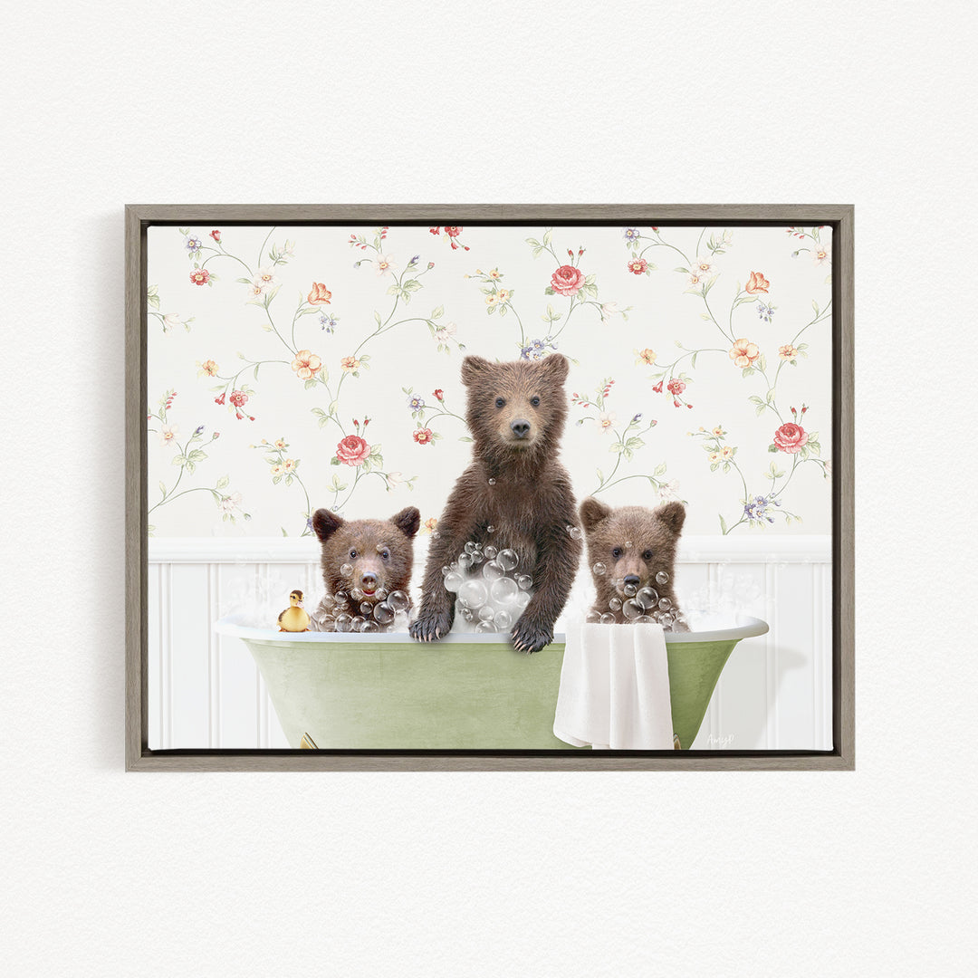 A framed image depicting three bears sitting in a green bathtub, with one bear standing and the other two sitting.