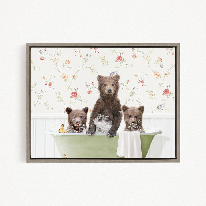 A framed image depicting three bears sitting in a green bathtub, with one bear standing and the other two sitting.