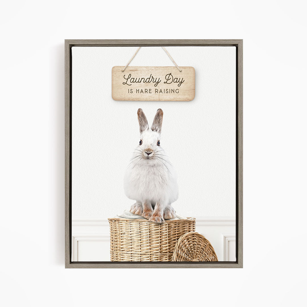 A white rabbit sitting in a wicker basket, with a wooden sign above that says "Laundry Day is Rare Raising".