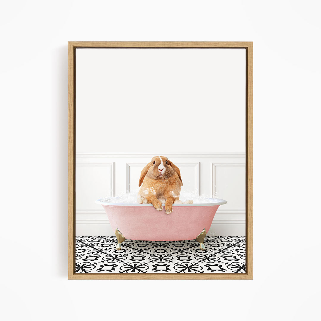 A brown rabbit sitting in a pink bathtub filled with bubbles, surrounded by a black and white patterned floor.