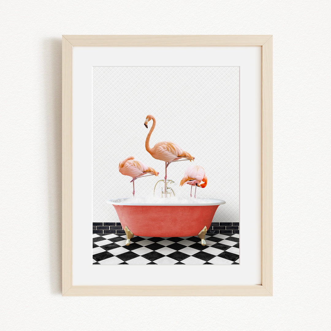 A framed image depicting three flamingos standing in a red bathtub on a black and white checkered floor.
