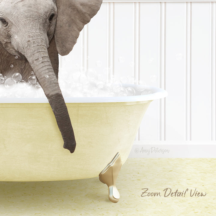 A baby elephant is sitting in a bathtub filled with bubbles, with its trunk reaching out towards the water.