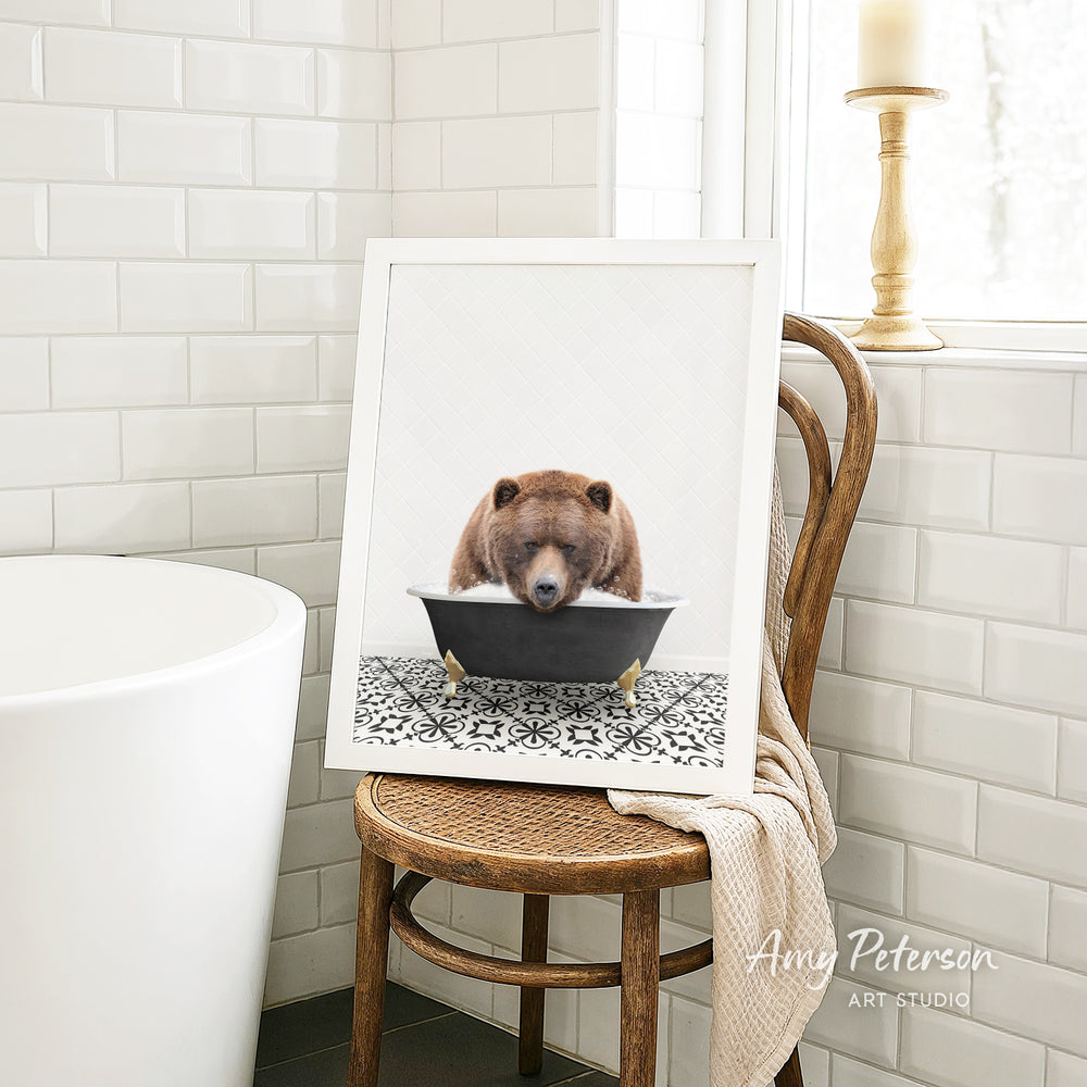 A brown bear is sitting in a bathtub, surrounded by a black and white patterned tile floor.