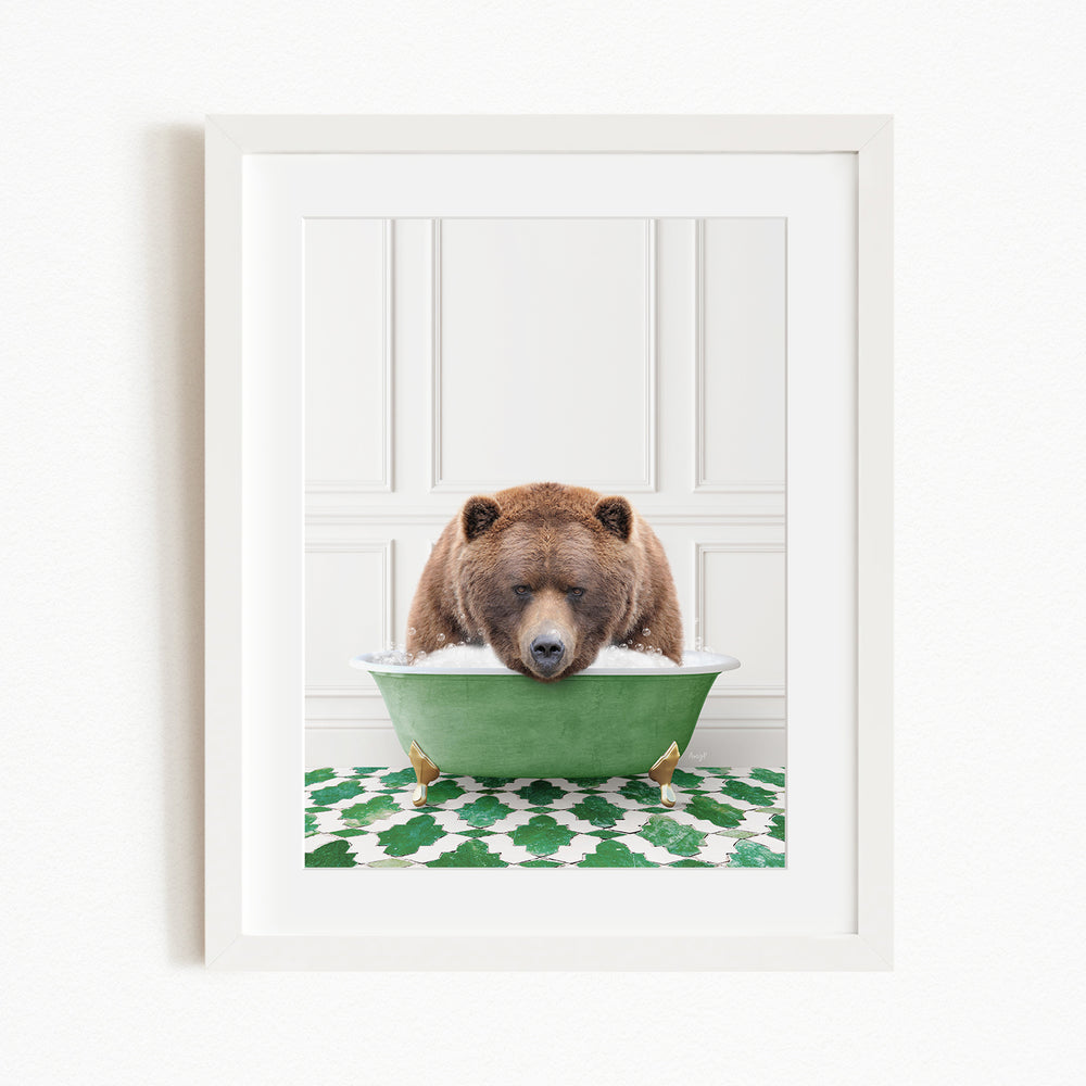 A brown bear is sitting in a green bathtub filled with water, appearing to be enjoying a relaxing bath.