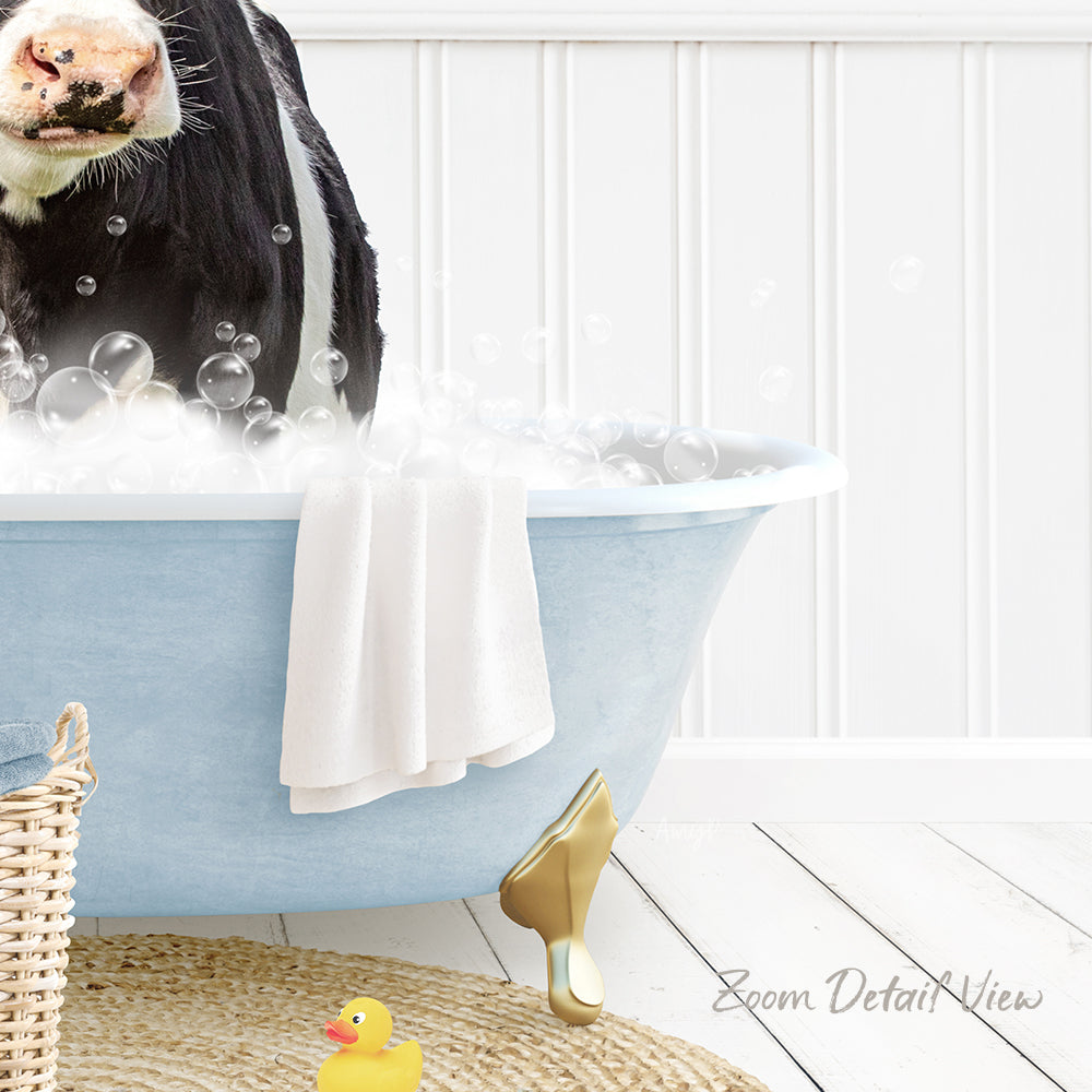 A black and white cow is standing in a blue bathtub filled with bubbles, surrounded by a yellow rubber duck and a white towel.