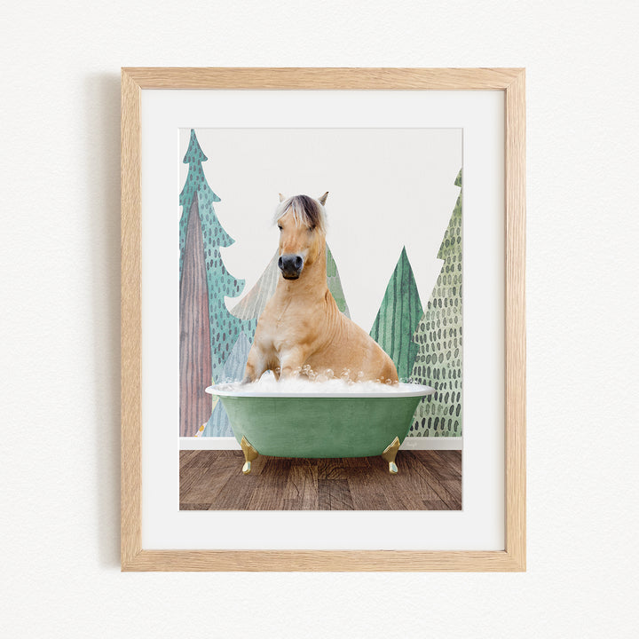 A light brown horse is sitting in a green bathtub, surrounded by a forest-themed background with trees and a snowy landscape.