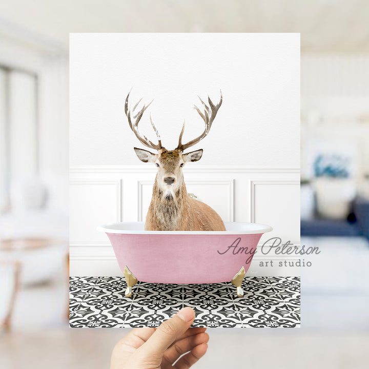 a hand holding a card with a picture of a deer in a bathtub