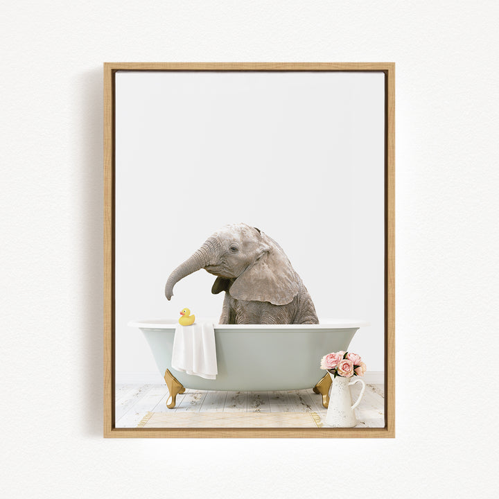 A baby elephant sitting in a bathtub, surrounded by a yellow rubber duck, a white towel, and pink flowers.
