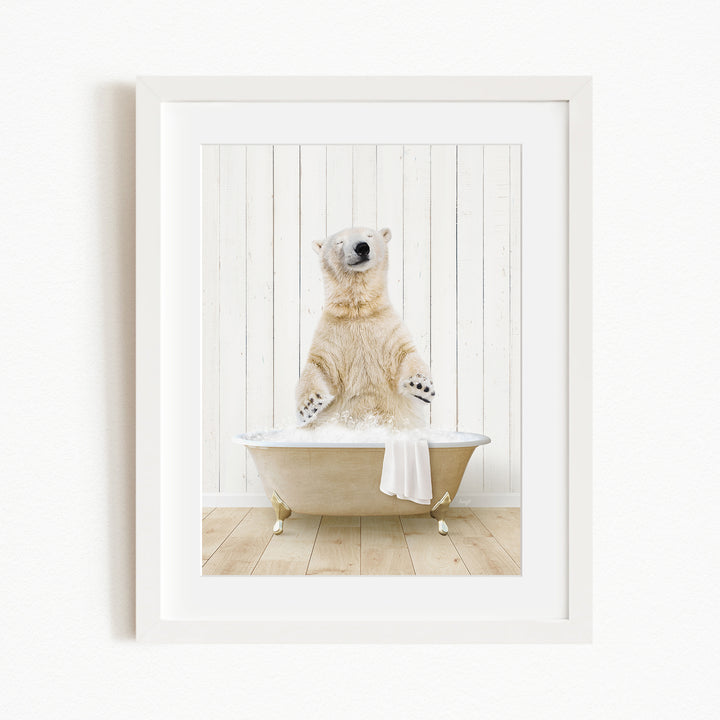A polar bear sitting in a bathtub filled with water, with its paws raised in the air.