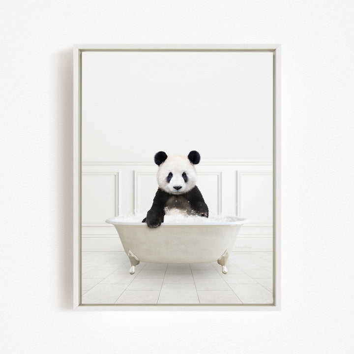A panda bear sitting in a white bathtub filled with bubbles, looking directly at the camera.