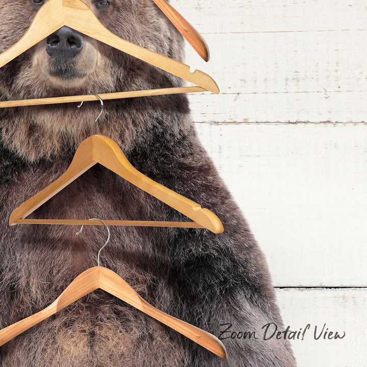 A close-up of a bear's head and neck, with several wooden hangers hanging from its mouth and neck.