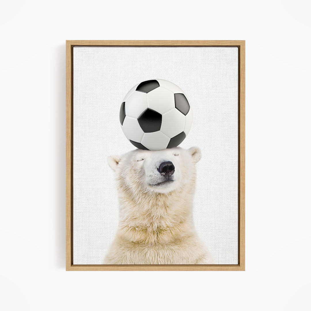 A polar bear balancing a soccer ball on its head.