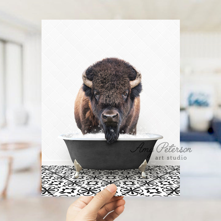 a person holding up a card with a picture of a bison in a bathtub