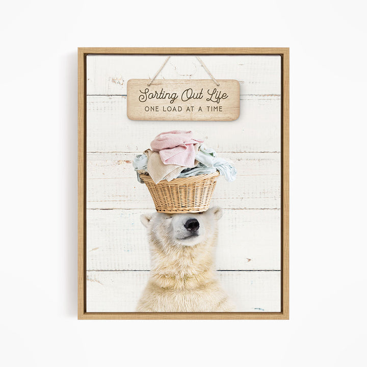 A polar bear balancing a basket of laundry on its head, with a sign above that says "Sorting Out Life One Load at a Time".
