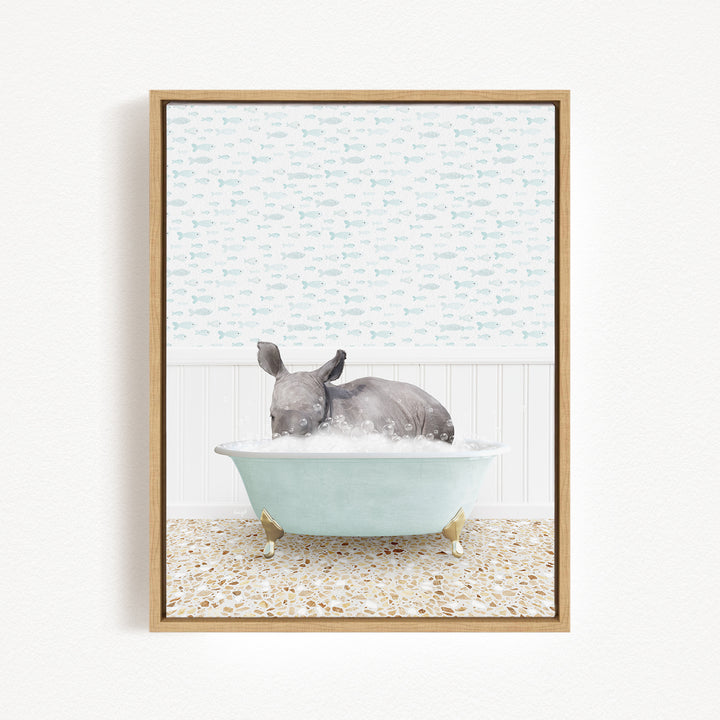 A gray rhinoceros is sitting in a light blue bathtub filled with water, surrounded by a patterned tile floor.