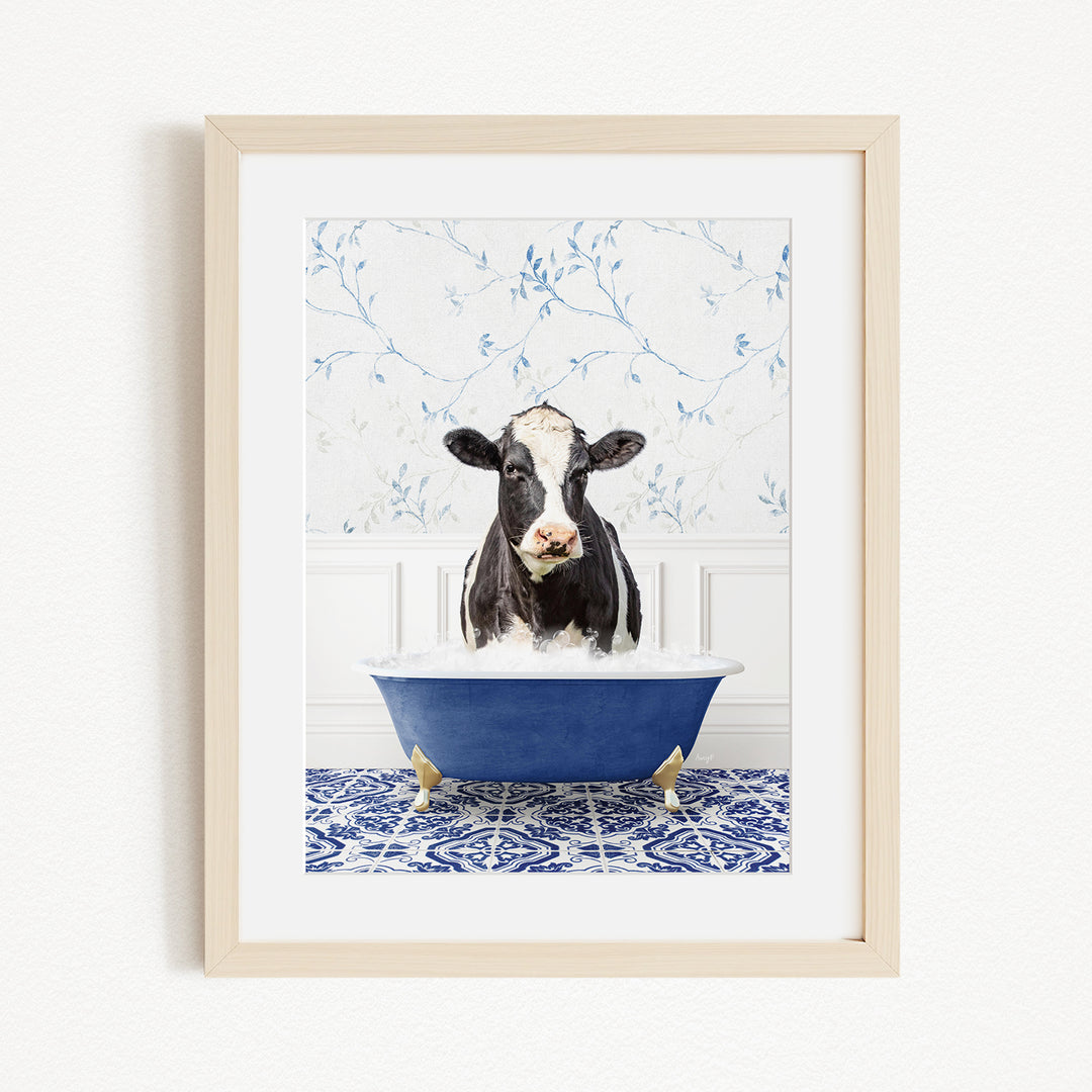 A black and white cow is sitting in a blue bathtub filled with water, creating a whimsical and humorous scene.