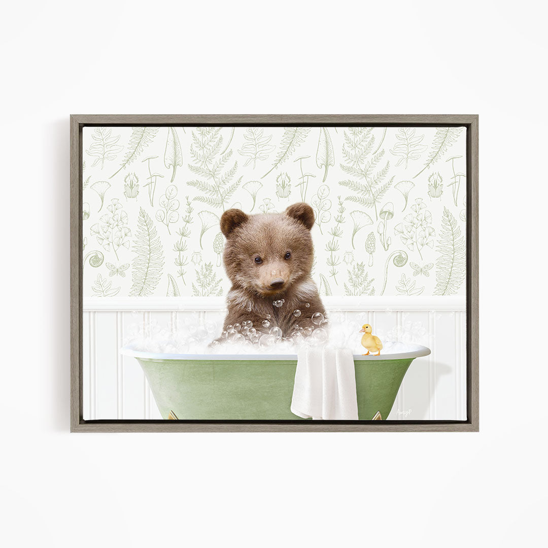 A brown bear sitting in a green bathtub filled with bubbles, with a yellow duck floating nearby.