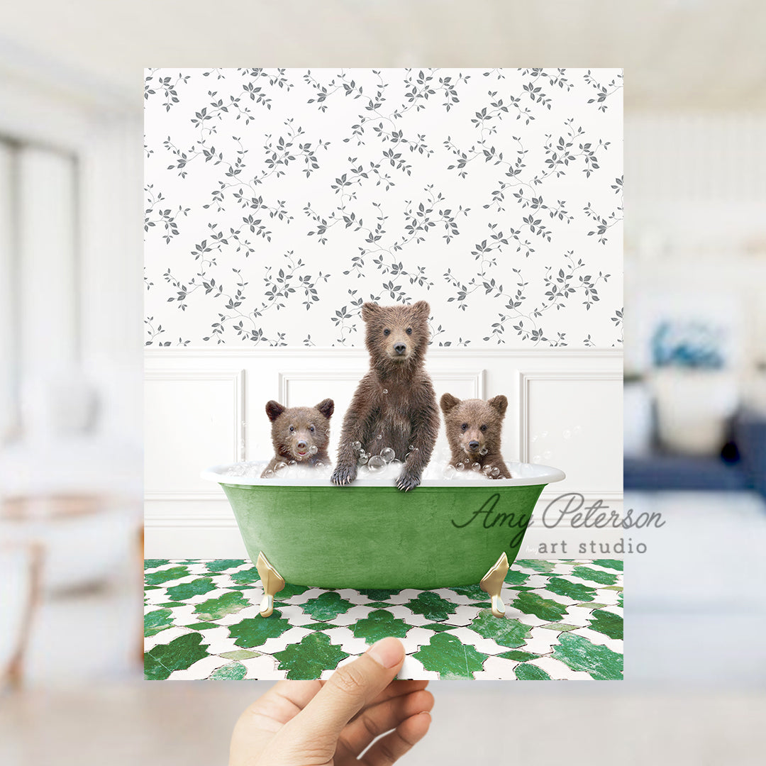 a person holding a card with three bears in a bathtub