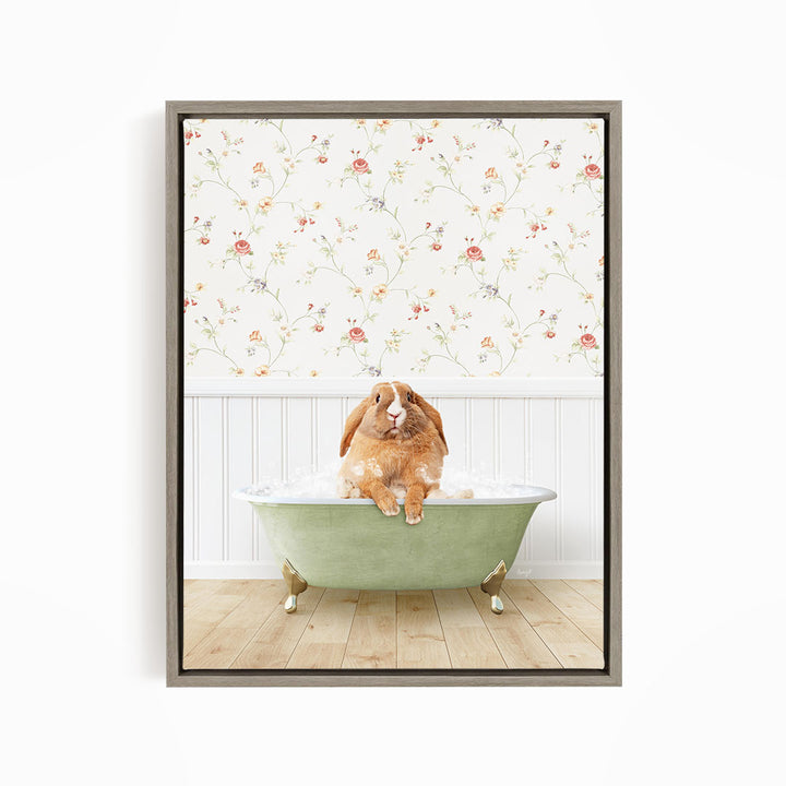 A brown rabbit sitting in a green bathtub filled with water, with a floral wallpaper in the background.
