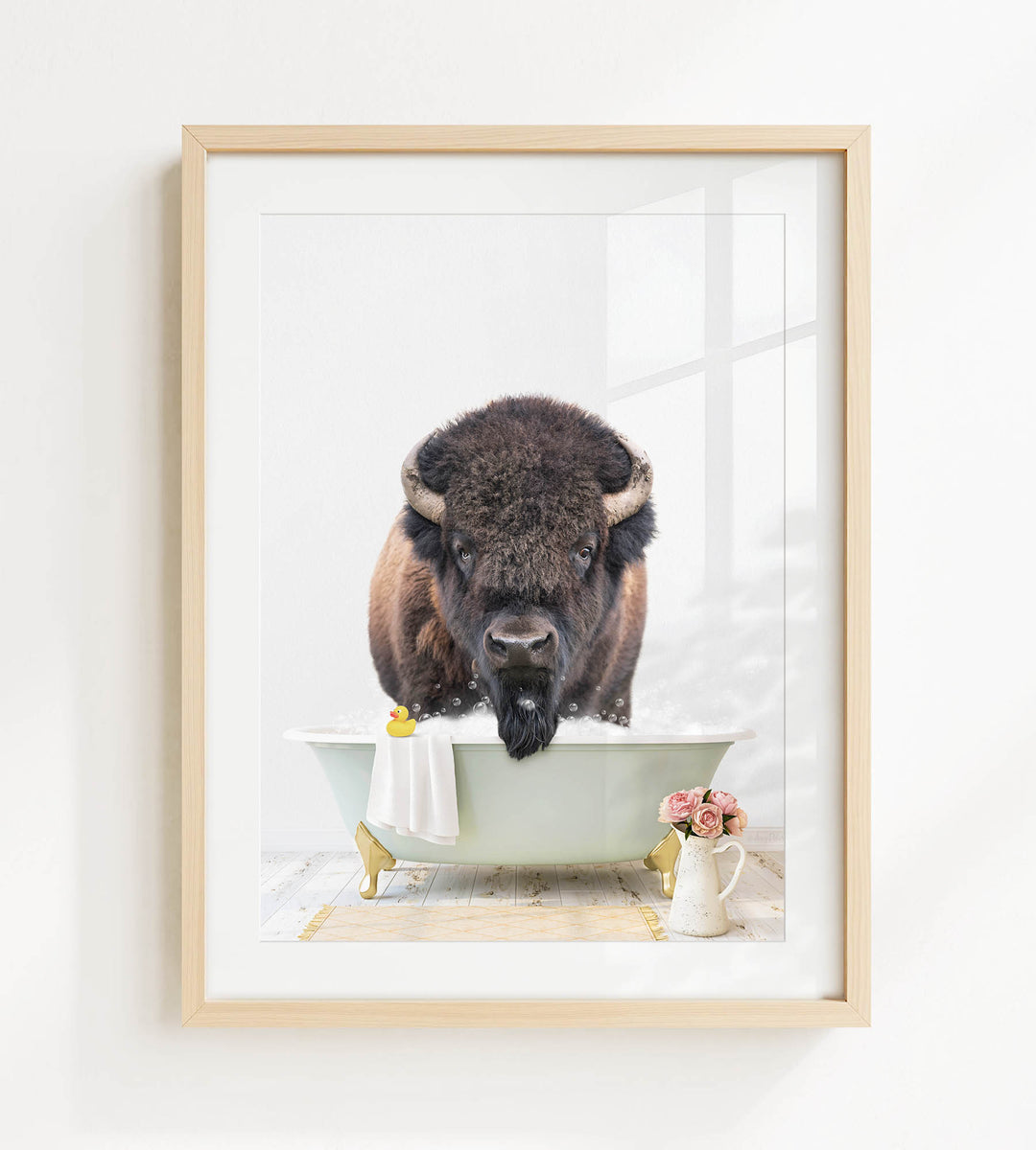 A buffalo with large horns is sitting in a bathtub filled with water, surrounded by flowers and a yellow rubber duck.